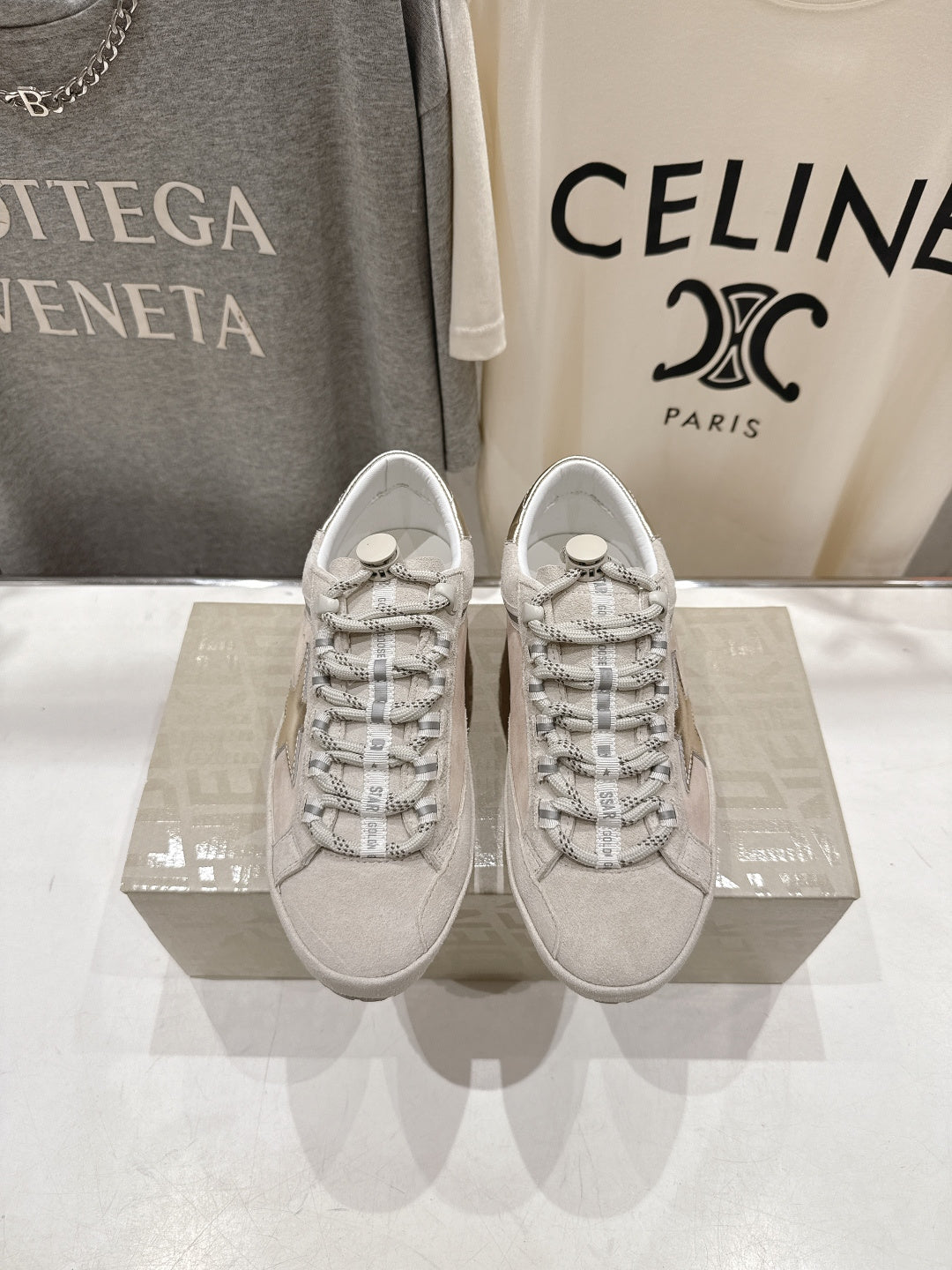 Golden Goose light gray lace-up sneakers with patterned laces and logo detail, pair