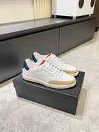 YSL unisex sneakers on box, white upper with red accent and navy lining, beige sole