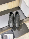 Dark gray lace-up sneakers with textured uppers and rubber sole