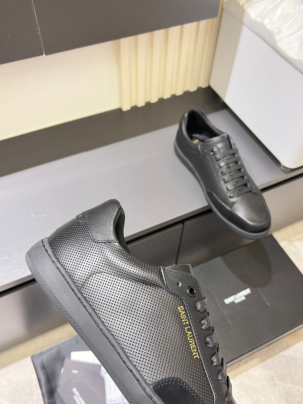 Dark gray lace-up sneaker with textured side panel and front eyelets