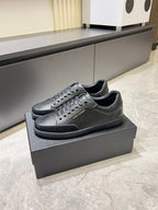Dark gray lace-up sneakers with perforated toe and side stripe