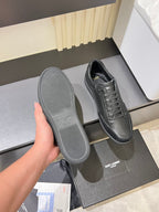 Dark gray sneaker sole held up, with lace-up upper on the shelf