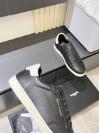 Unisex YSL sneakers close-up: dark perforated leather, lace-up front, white sole.