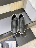Unisex YSL sneakers in dark textured leather, lace-up front, white rubber sole.