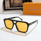 Black sunglasses with yellow reflective lenses and gold bridge detail.