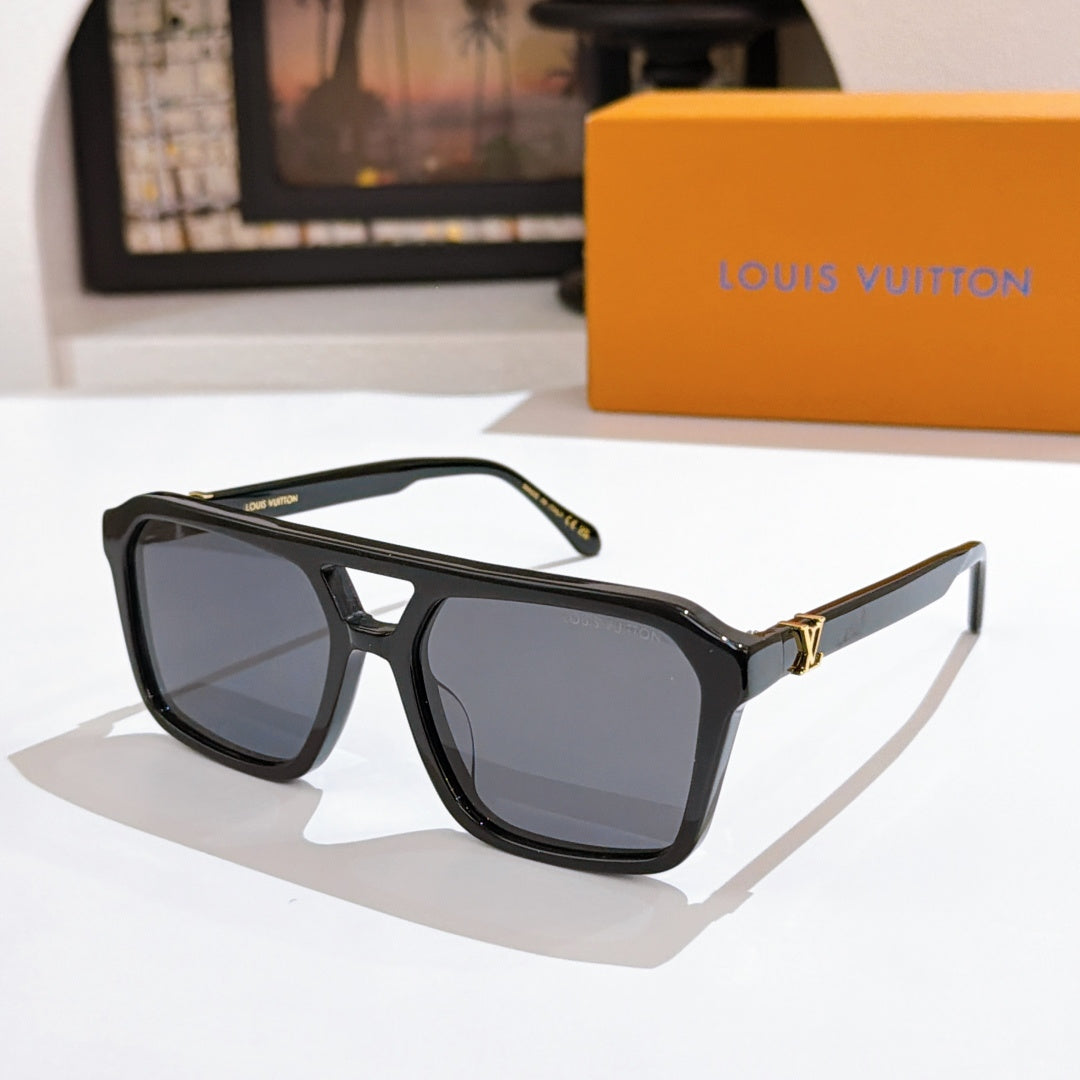 Black acetate sunglasses with dark lenses and monogram temples, gold accents.
