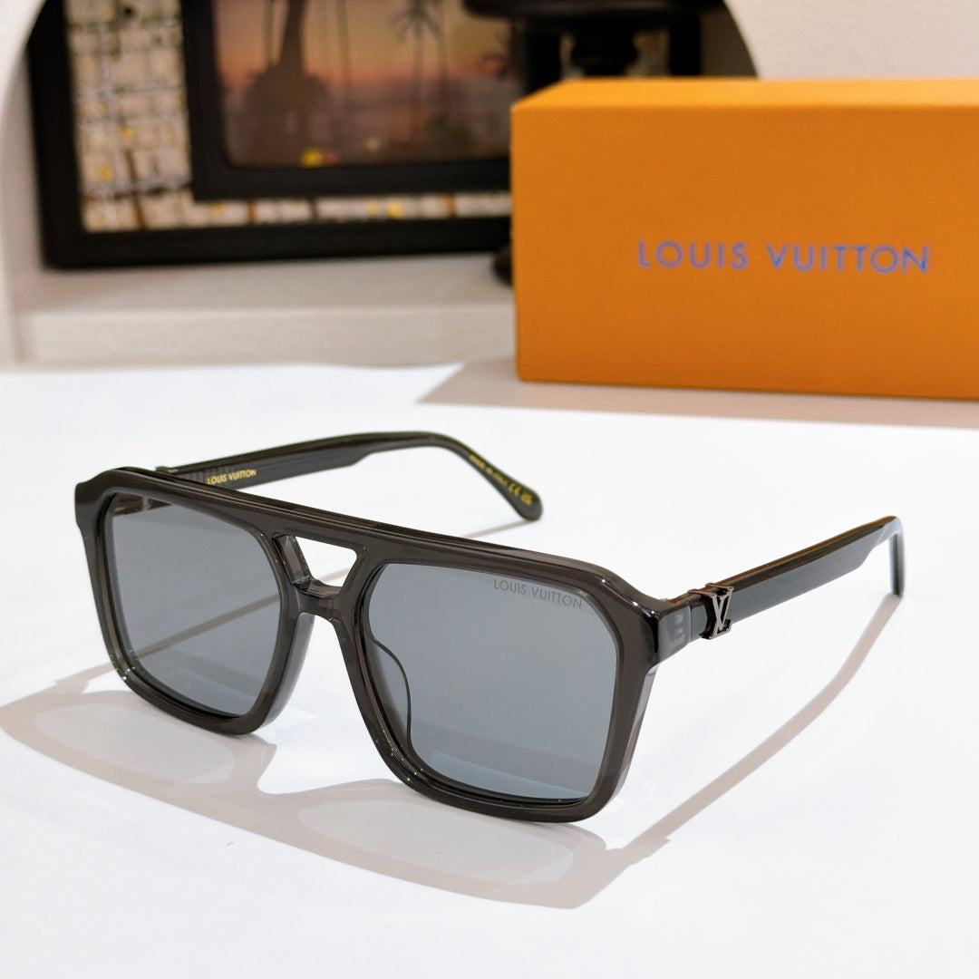 Black sunglasses with clear gray lenses and gold bridge detail.