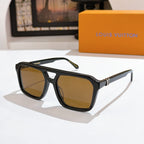 Black sunglasses with amber tinted lenses and gold bridge detail.