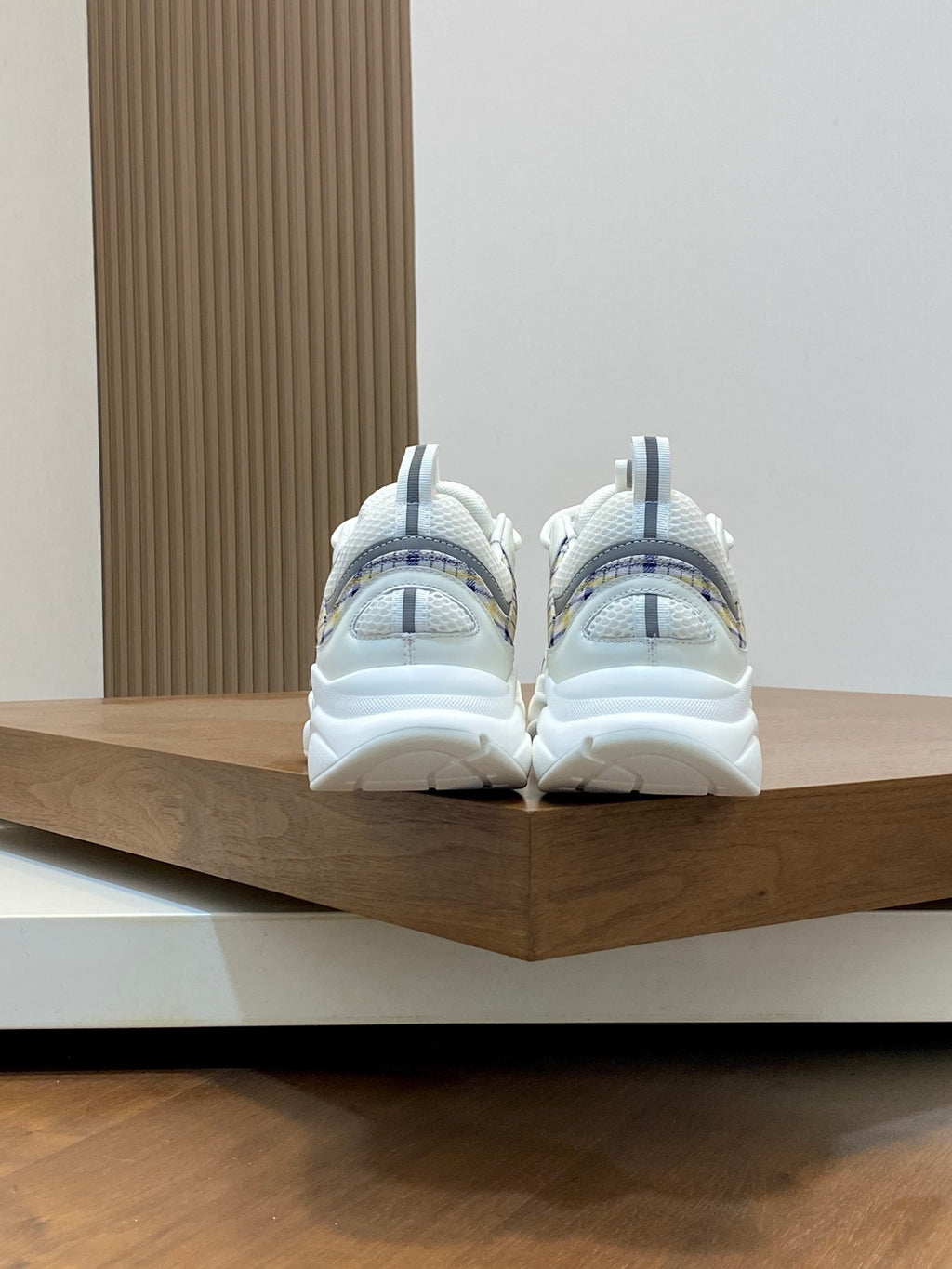 Back view of white and light blue low-top sneakers with padded heel