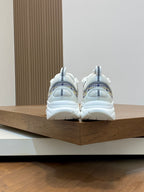 Back view of white and light blue low-top sneakers with padded heel