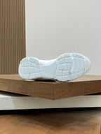 White sneaker outsole with tread pattern and raised heel