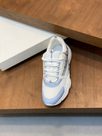White and light blue lace-up sneakers with textured upper and chunky sole