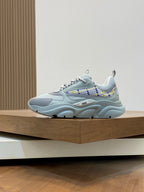 Light blue lace-up sneakers with chunky molded sole and patterned lace panel