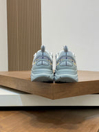 Back view of light blue lace-up sneakers with chunky sole and heel tabs