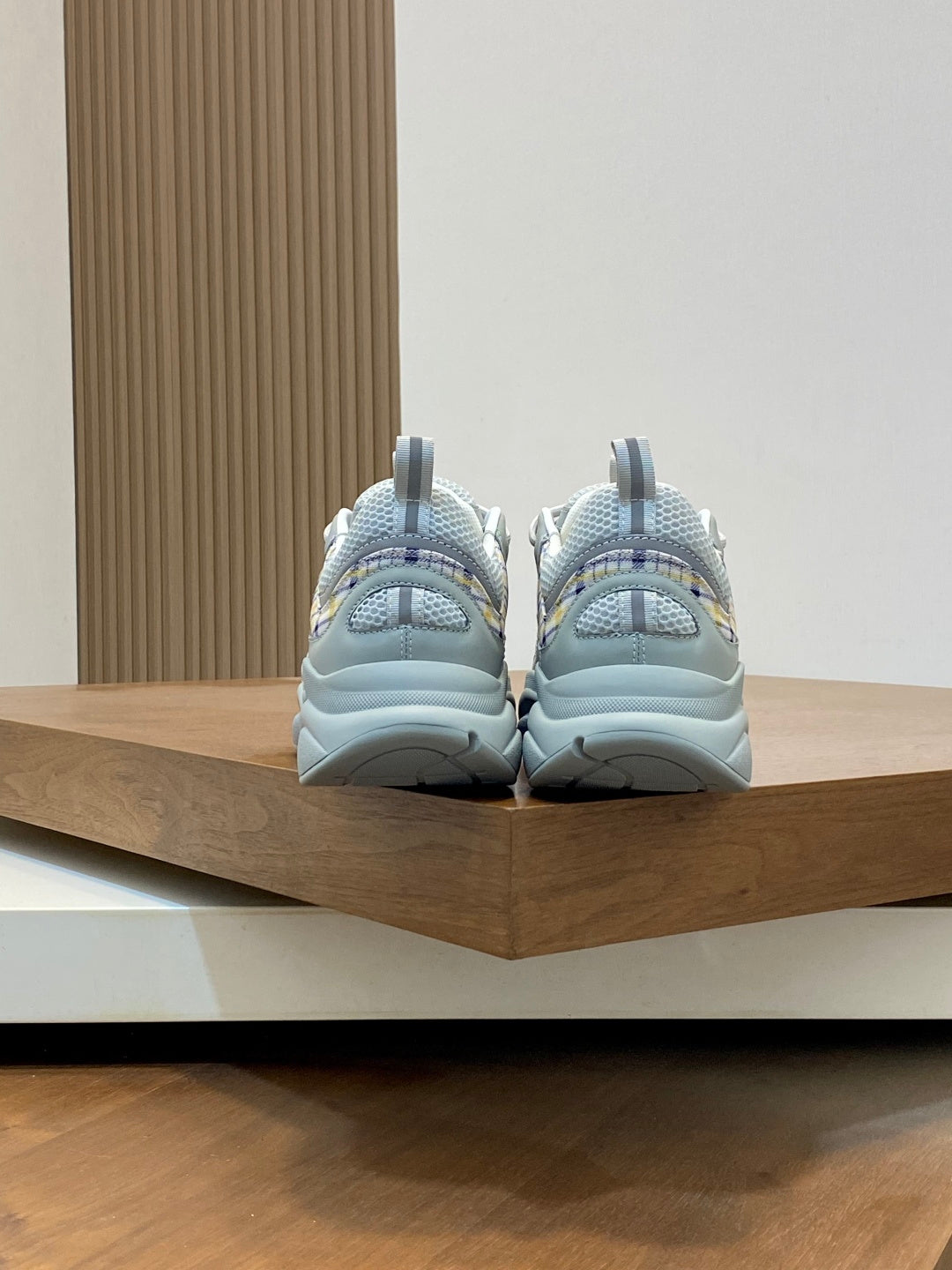Back view of light blue lace-up sneakers with chunky sole and heel tabs