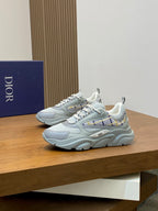 Light blue chunky lace-up sneakers with blue plaid accent on the side