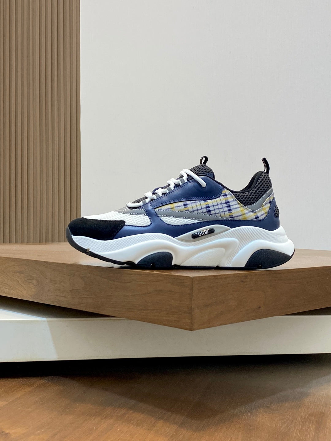 Dior unisex lace-up sneakers with blue plaid panel, navy accents, and thick white sole
