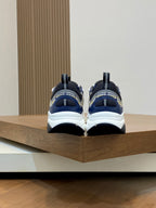 Dior unisex sneakers back view on shelf, navy heels with white sole and blue accents