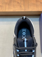 Dior logo on navy mesh tongue of lace-up sneaker, close-up view