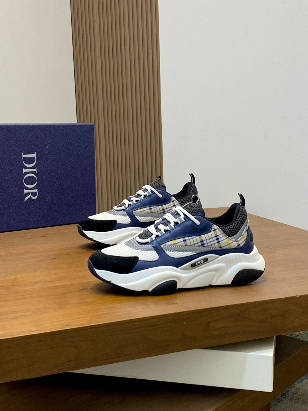 Dior unisex sneakers pair with blue plaid overlays, lace-up front, and sporty white sole