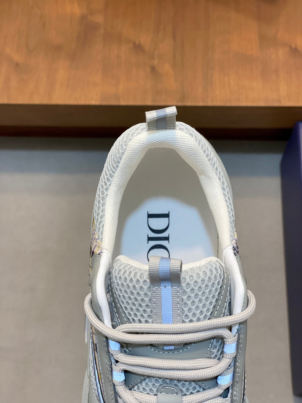 Light blue mesh sneaker with lace-up straps and Dior detail on the heel