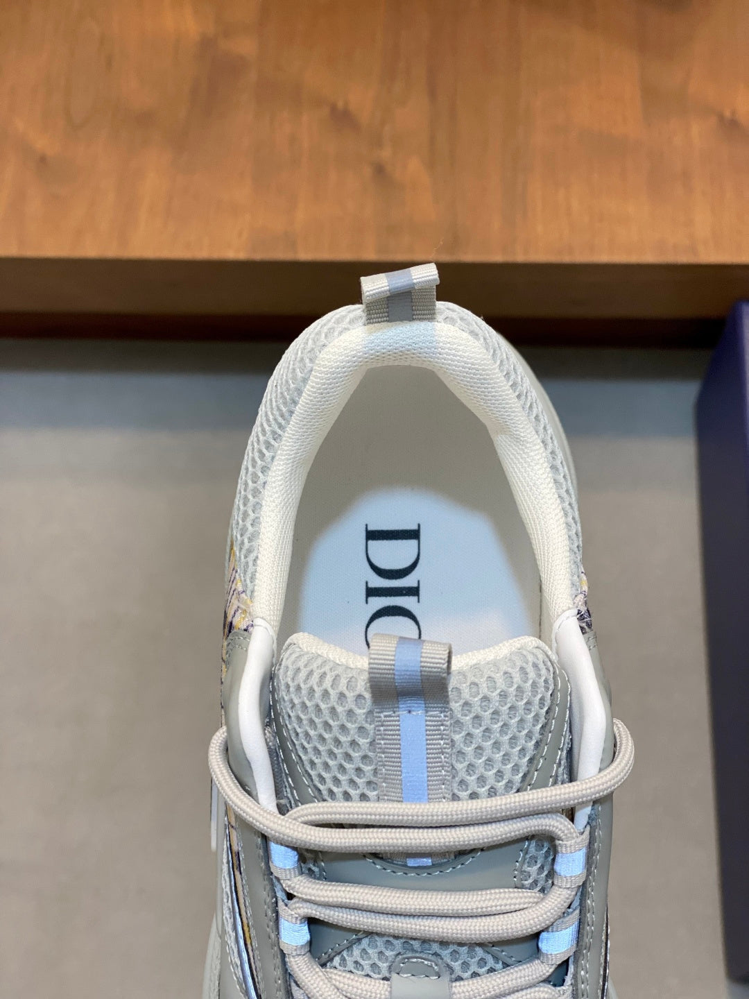 Light blue mesh sneaker with lace-up straps and Dior detail on the heel