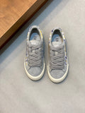 Grey low-top Dior sneakers with lace-up front and blue-yellow check panel