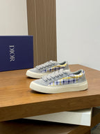Grey low-top lace sneakers with blue-yellow plaid trim and white cupsole