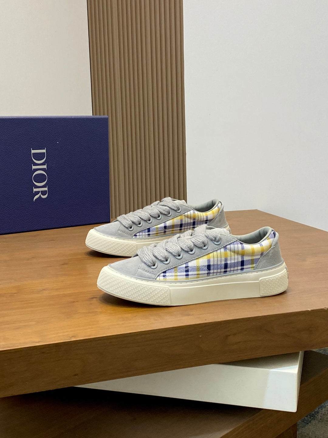 Grey low-top lace sneakers with blue-yellow plaid trim and white cupsole