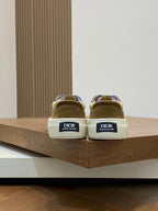 Back view of low-top sneakers showing heel tabs with DIOR label and textured white sole.