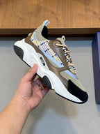 Unisex sneaker close-up: beige, navy and light plaid panel, white sculpted sole