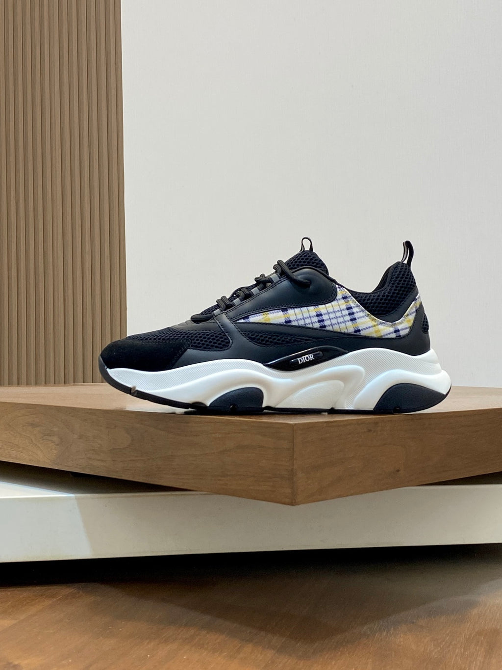 Navy lace-up sneaker with white sole, check-panel side detail and blue stripe heel