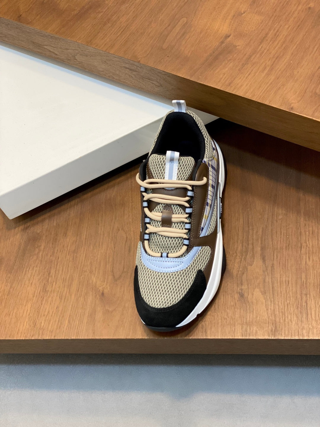 Unisex sneaker side view, beige mesh upper with navy trim and white sole