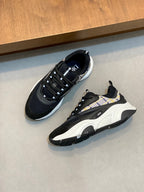 Pair of navy Dior sneakers with plaid side panels, lace-up design and chunky white soles