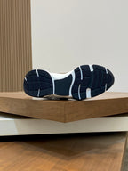 Unisex sneaker outsole view, navy and white rubber tread