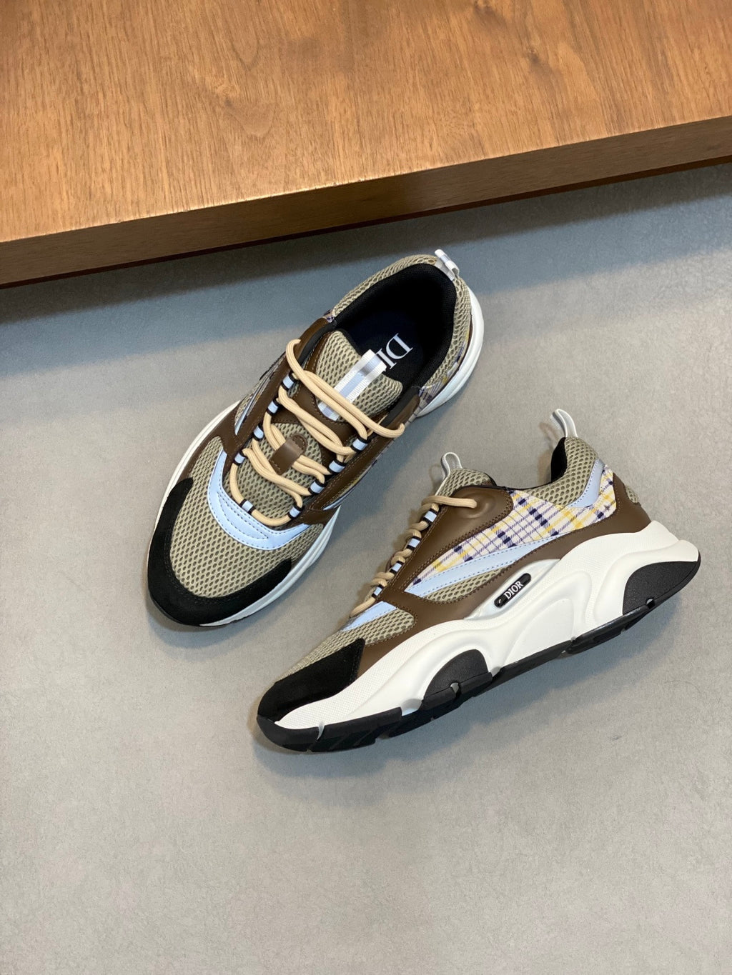 Unisex sneakers pair, beige mesh with navy toe and plaid side panels, chunky sole