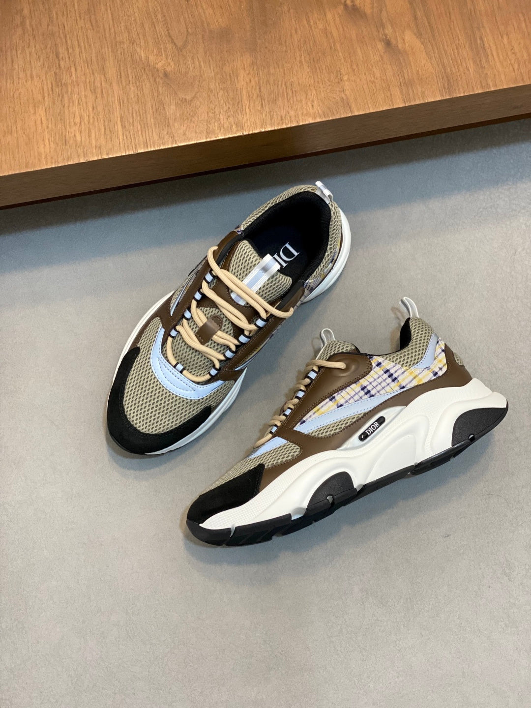 Unisex sneakers pair, beige mesh with navy toe and plaid side panels, chunky sole