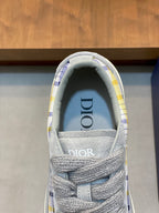 Grey low-top sneaker tongue with Dior logo and blue-yellow check lining