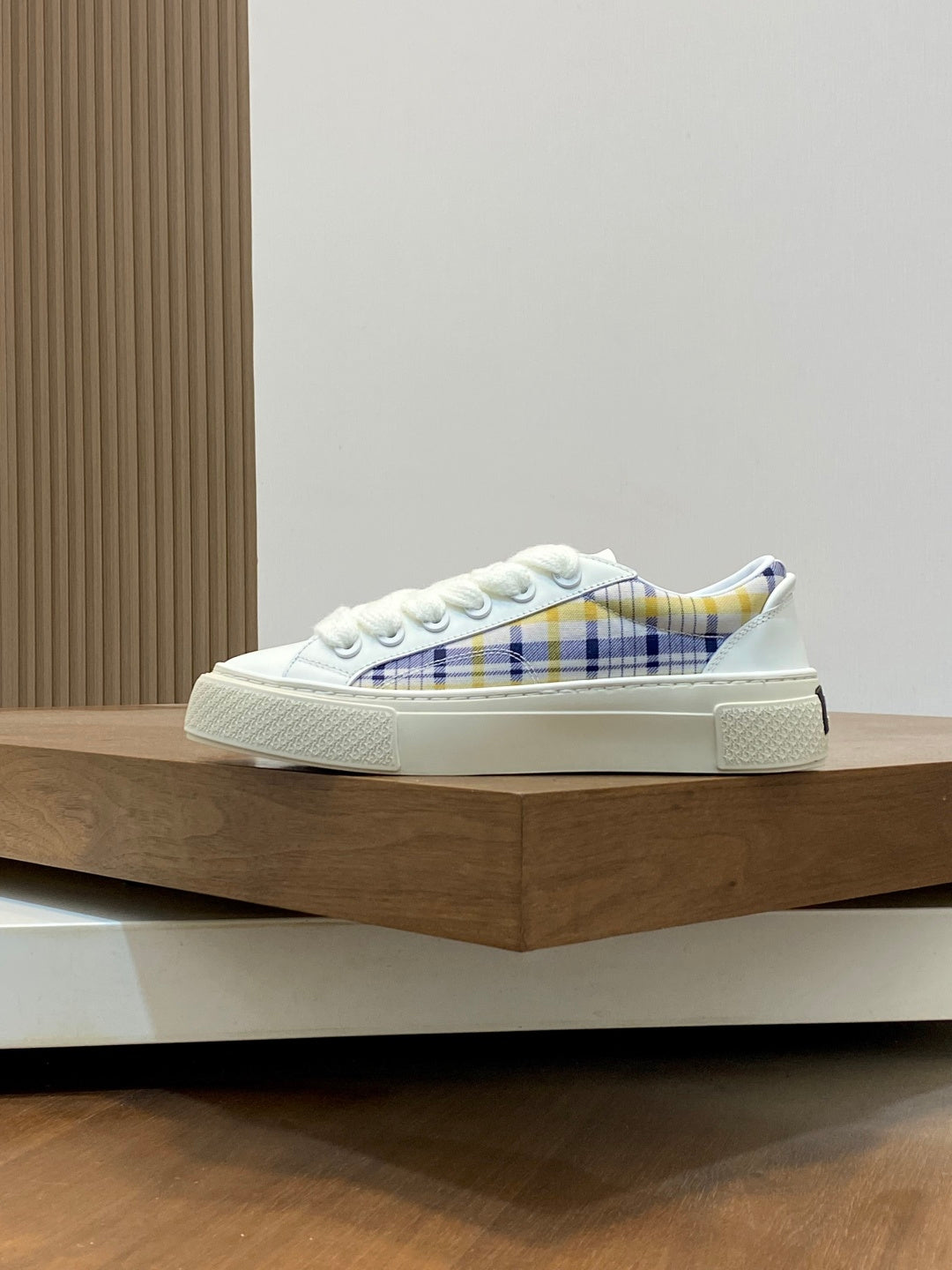 White low-top sneaker with blue plaid interior, lace-up, rubber cupsole.