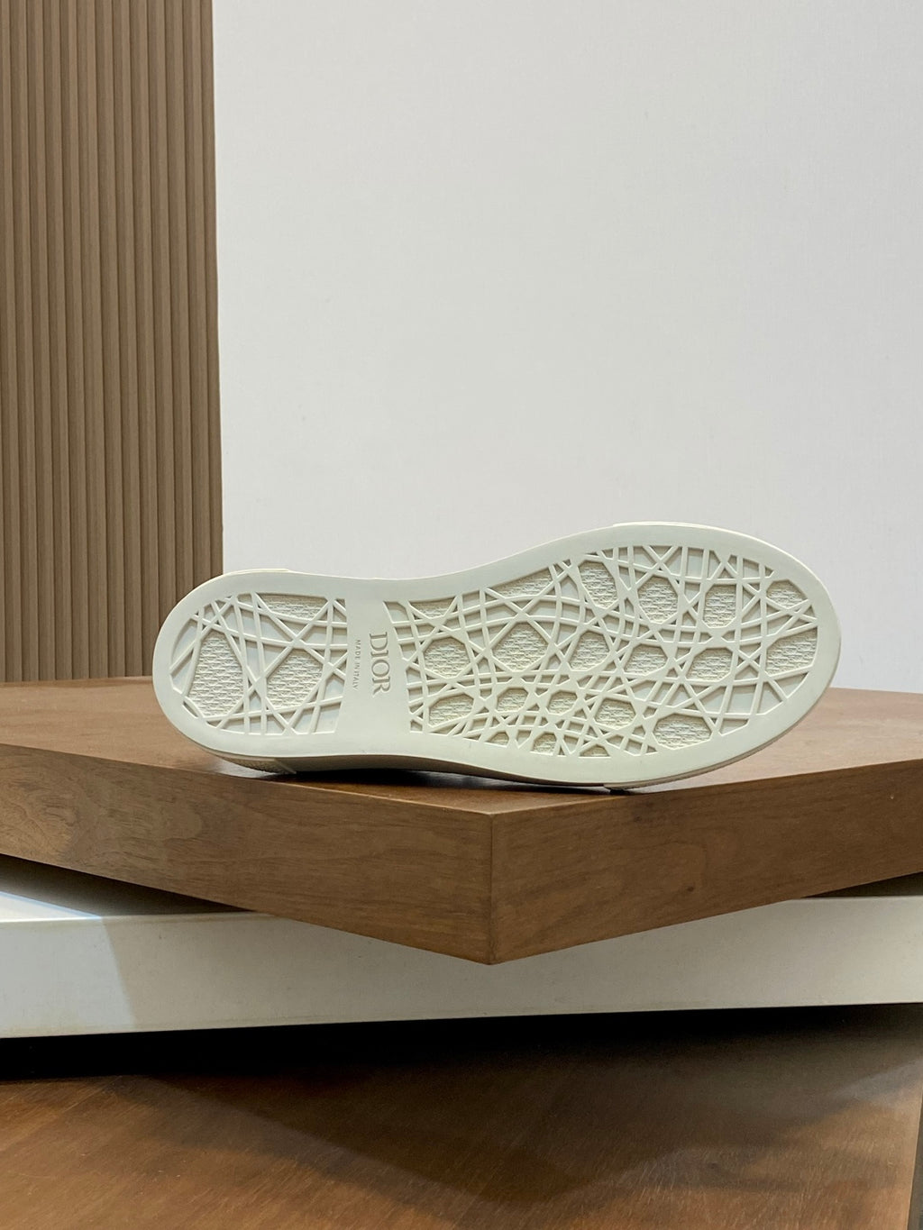 Shoe outsole of low-top sneakers in white with textured pattern tread.