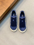 Navy blue low-top sneakers with lace-up and white/yellow plaid side panels.