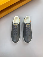 Pair of dark leather low-top sneakers with gray laces and white midsoles