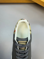 Dark navy sneakers with patterned collar lining and BURBERRY logo on the tongue