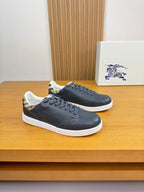 Dark navy leather sneakers with white rubber sole and lace-up front
