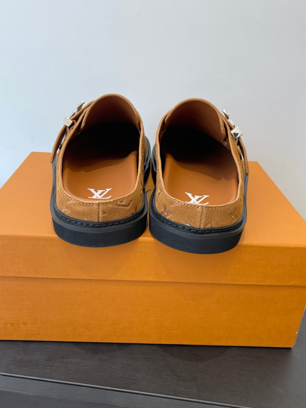 Louis Vuitton monogram sandal back view, tan slip-on with silver buckle and black sole