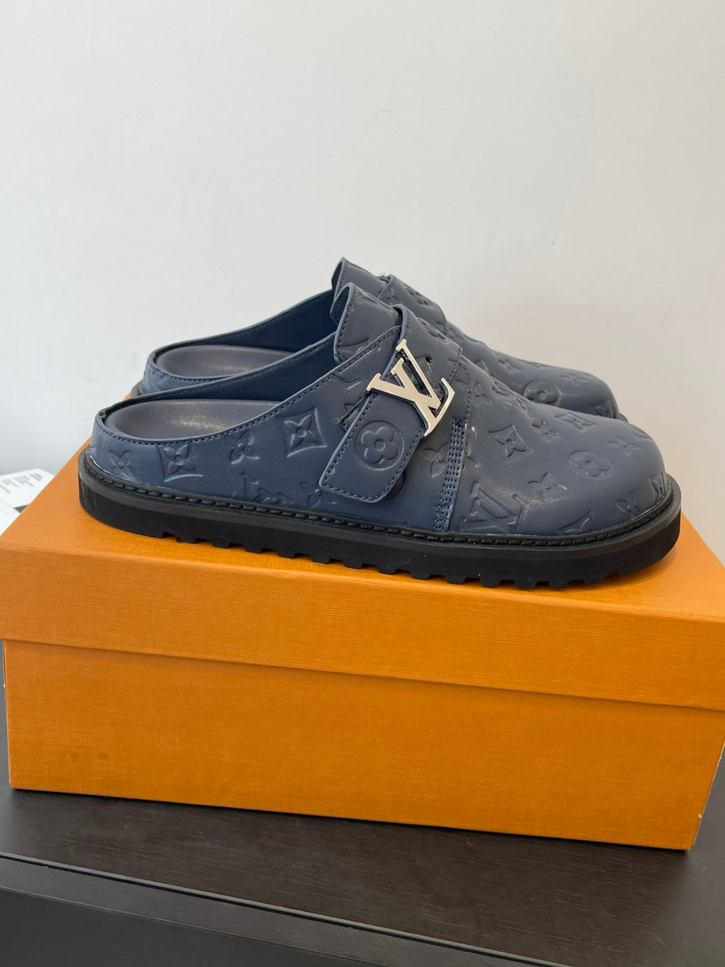 Louis Vuitton navy embossed slide sandals with side strap and gold-tone metal hardware