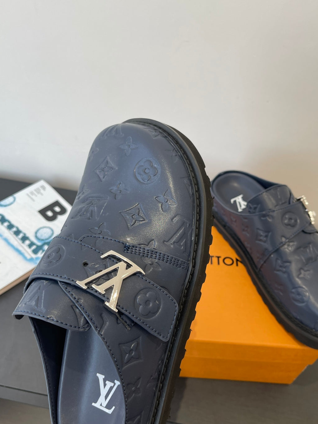Louis Vuitton navy embossed slide sandal with gold logo buckle strap
