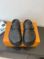 Louis Vuitton sandals in dark leather with embossed monogram and buckle strap