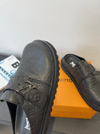 Louis Vuitton leather slide sandals with embossed monogram and buckle strap