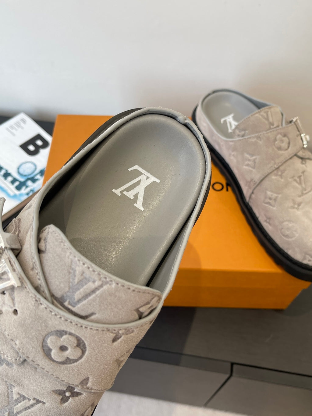 Louis Vuitton monogram slide sandals, close-up of beige footbed with LV logo